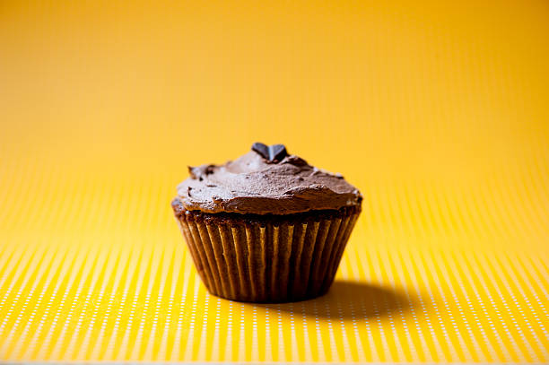 istock One homemade chocolate cupcake with brown cream 469584971