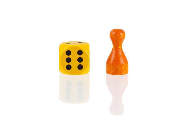 istock One orange pawn and a yellow dice 469586779