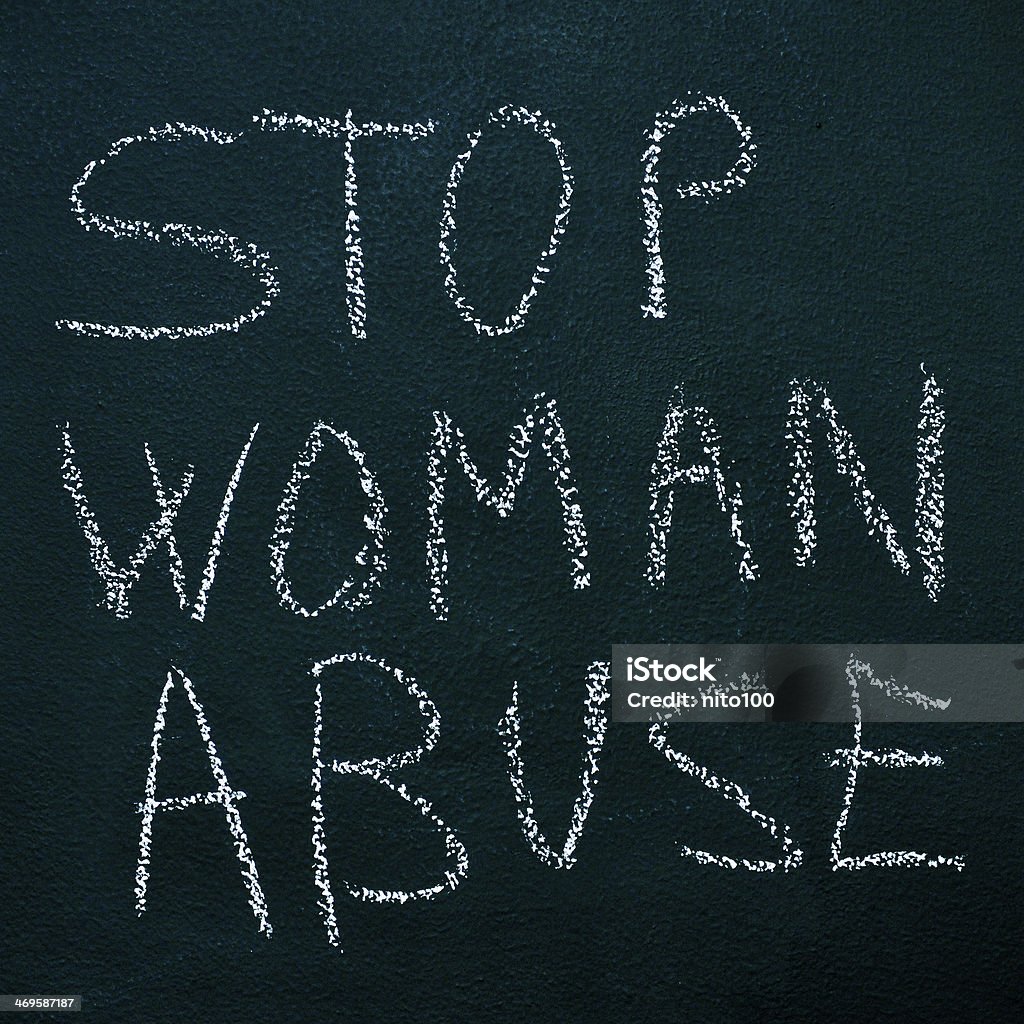 stop woman abuse sentence stop woman abuse written with chalk on a chalkboard Adult Stock Photo