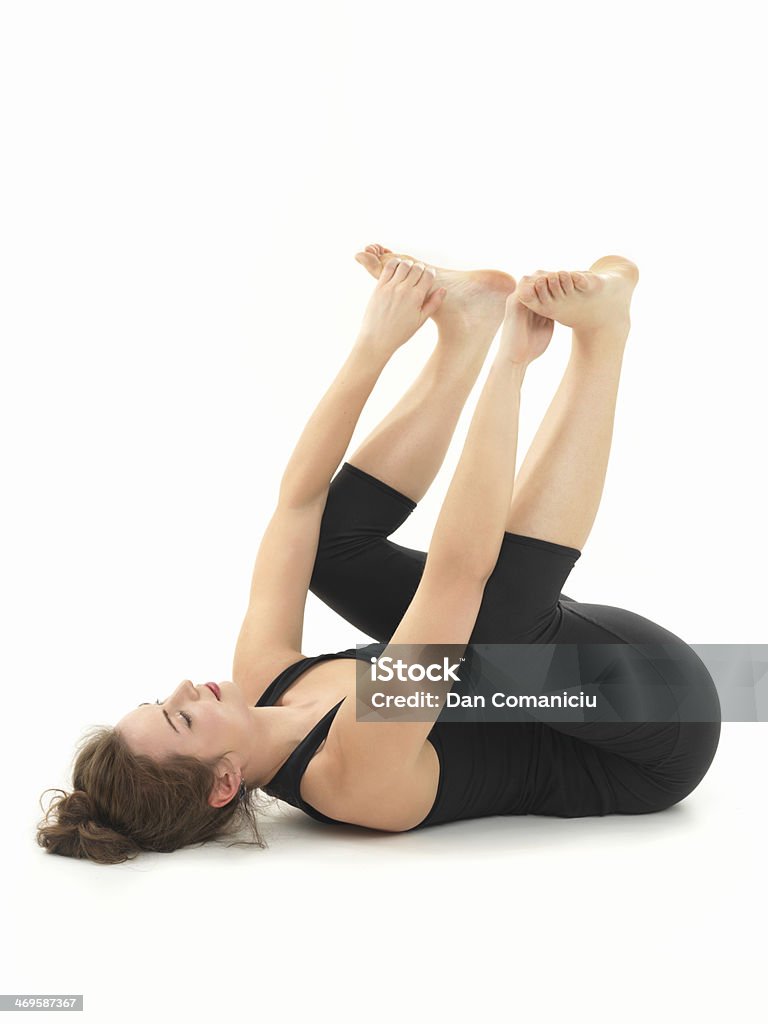relaxation yoga posture young woman practicing relaxation yoga pose, full side view, dressed in black, on white background Ananda Temple Stock Photo