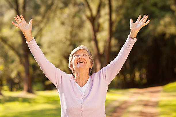 istock healthy elderly woman arms outstretched 469587787