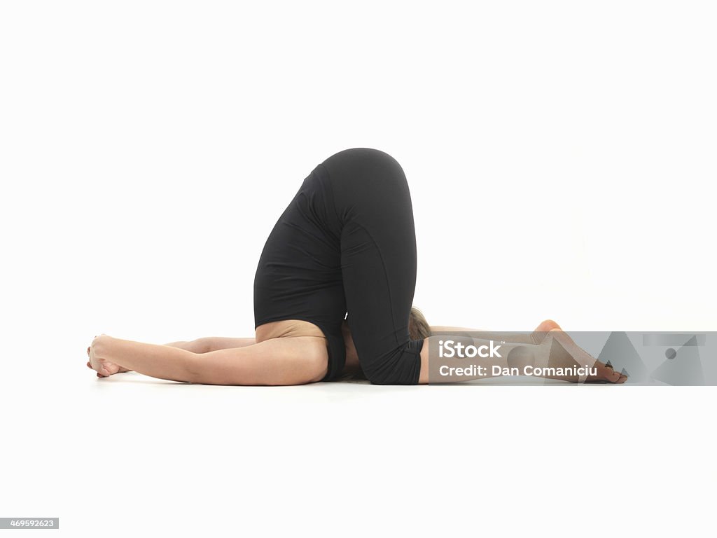 advanced yoga pose young woman in difficult  contorted yoga posture, body side view Contortionist Stock Photo