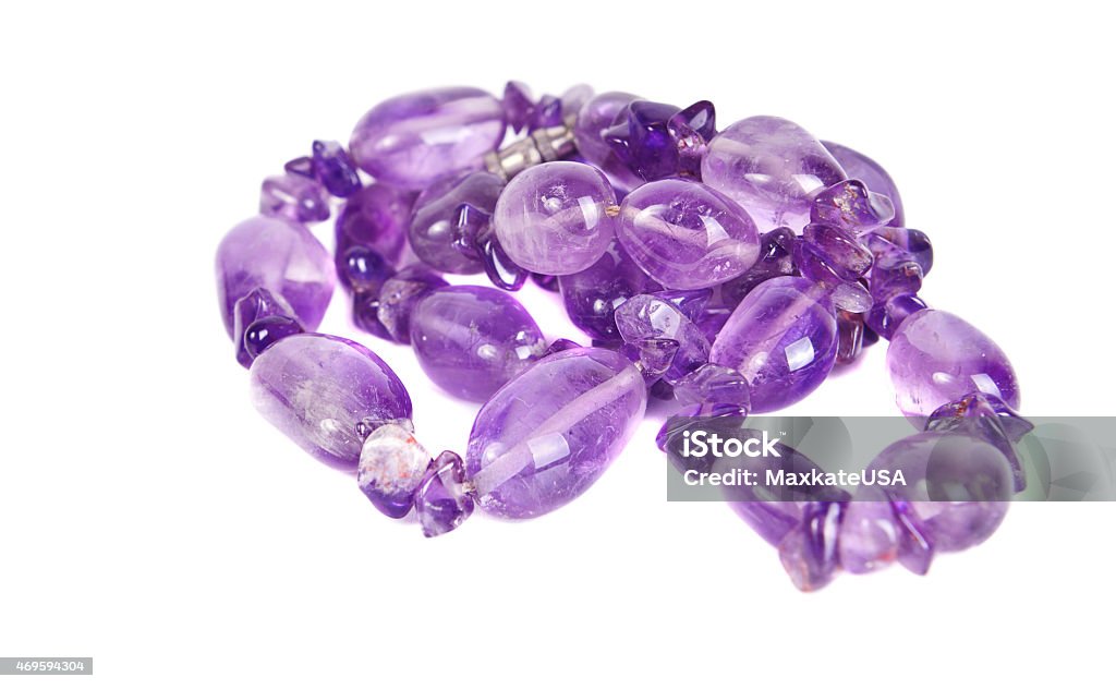 Amethyst beads Аmethyst beads jewelery on the white background. . 2015 Stock Photo