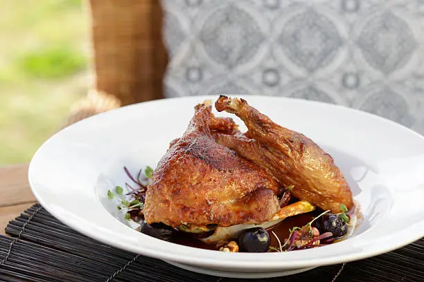 Twice cooked duck with cherry dressing, roasted parsnips , walnuts and bitter greens