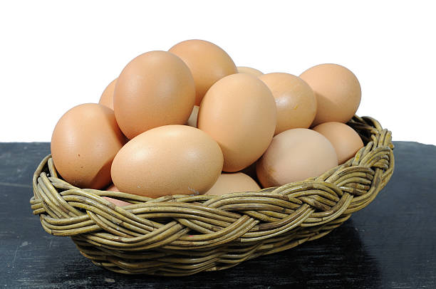 istock Many eggs in rattan basket on black wooden table 469595521