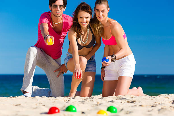 istock Man and women playing boule on beach 469597539