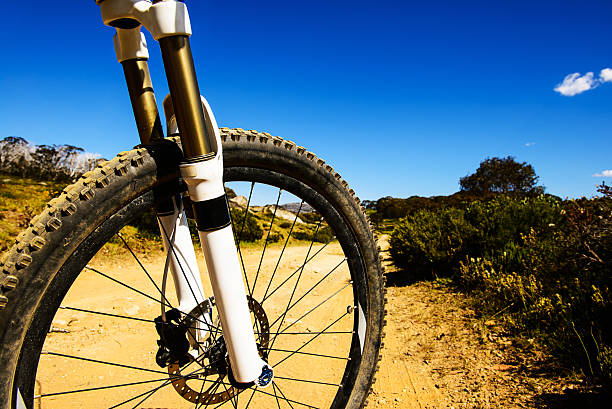 Looking through a mountain bike wheel in mountains. Mountain bike background with a copy space.