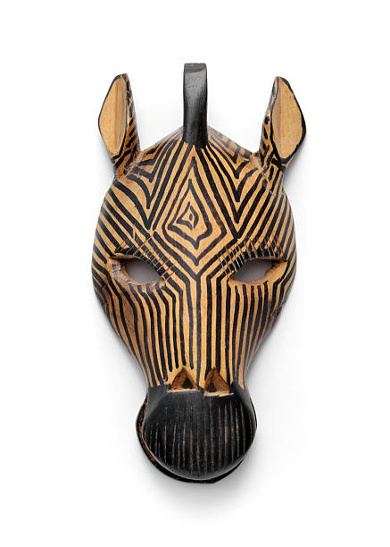 Zebra Mask Hand carved wood zebra mask from South Africa on a white background with shadows. Purchased from a street vendor outside of Cape Town. It's origins are unknown but it is believed to symbolize releasing the animal within the human being and the relationship between man and animal. carving craft product stock pictures, royalty-free photos & images