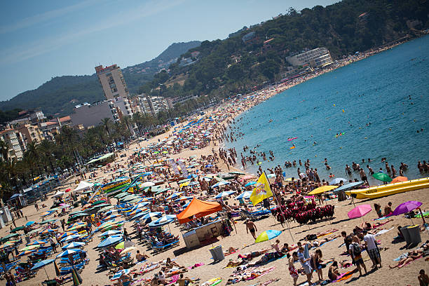 istock People and sun umbrellas on the beach 469600846
