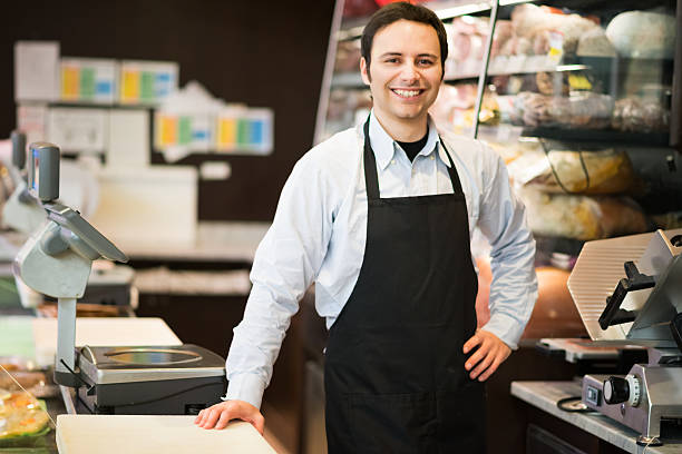 istock Smiling shopkeeper working in a shop 469601076