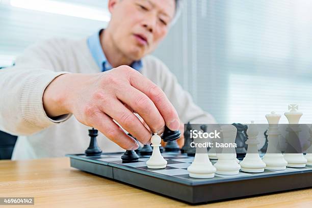 Senior Man Playing Chess Stock Photo - Download Image Now - 2015, 60-69 Years, Active Seniors