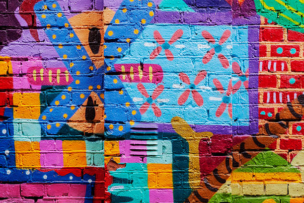 Colorful red yellow and blue graffiti on a brick wall. stock photo
