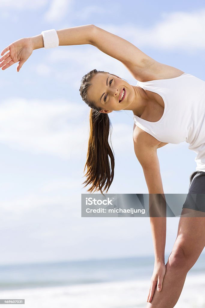 happy woman exercising happy young woman exercising outdoors Active Lifestyle Stock Photo