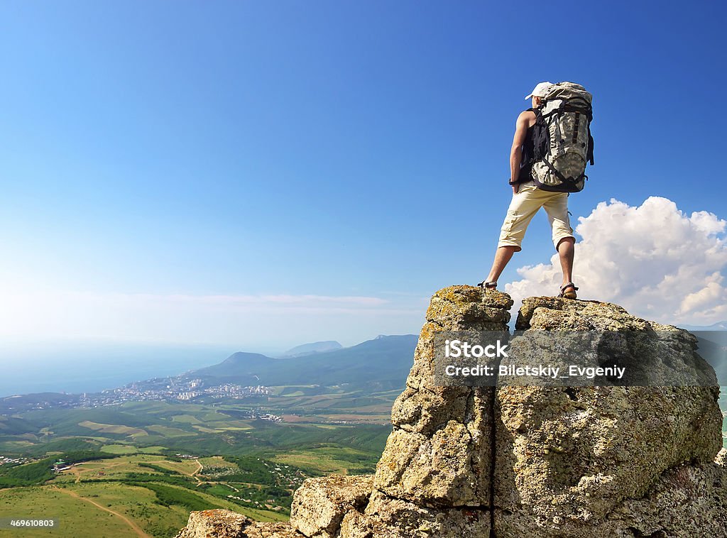 Tourist Tourist on the high rock. Sport and active life concept Activity Stock Photo