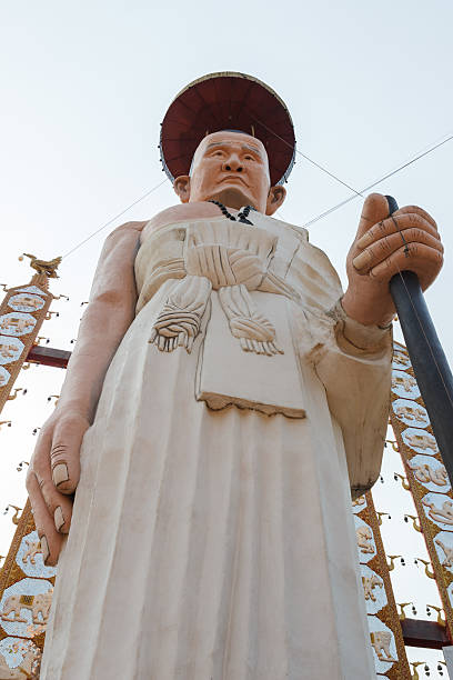 istock buddhist monk in white robe statue with walking stick 469611936