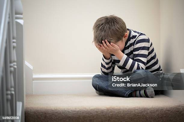 Upset Problem Child Sitting On Staircase Stock Photo - Download Image Now - Child, Sadness, Boys