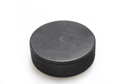 A hockey puck on a white background