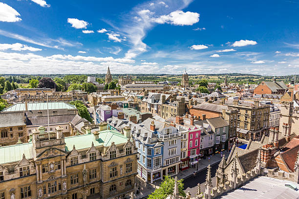 Aerial view of roofs in oxford, england Aerial view of roofs and spires of Oxford, England with blue sky in background oxford university photos stock pictures, royalty-free photos & images