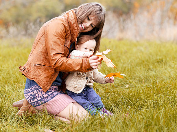 istock Family playing in autumn park 469618455