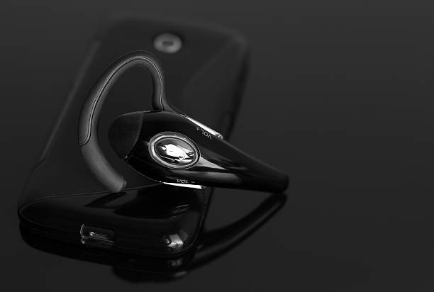 istock Close-up of handsfree bluetooth device near mobile phone. 469628552
