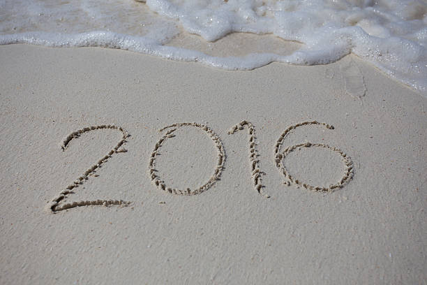 istock Numbers 2016 on beach - concept holiday background 469628582
