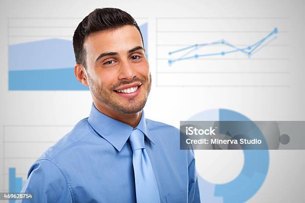Businessman In Front Of Business Charts And Diagrams Stock Photo - Download Image Now