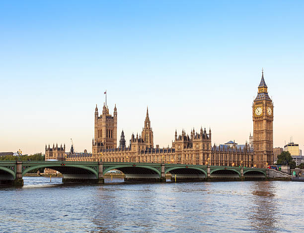 London - Big Ben, Westminster building with Thames at sunrise London - Big Ben and Westminster building with Thames river in the foreground, enlighted by the rising sun just before 7 am, what promises to become a wonderful day. Clean warm colors. westminster bridge stock pictures, royalty-free photos & images