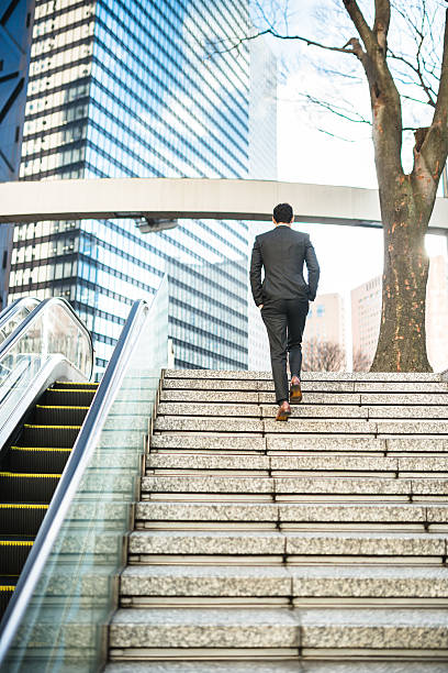 istock business man descending the steps on wall street 469634542