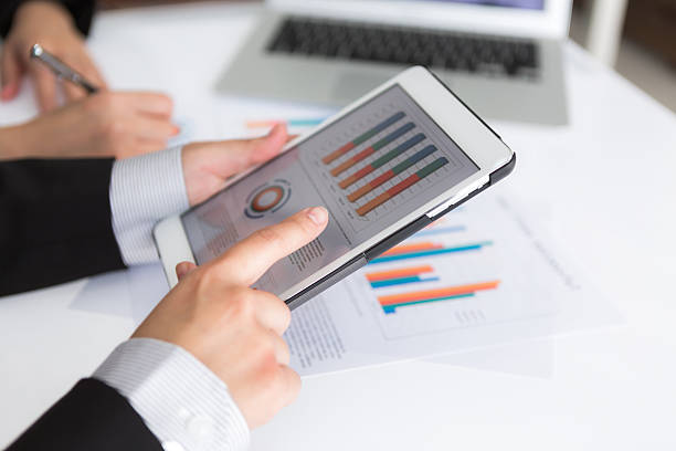 istock Close-up of business team using digital tablet with financial di 469635233
