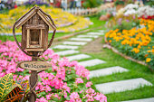 Welcome sign on colorful garden