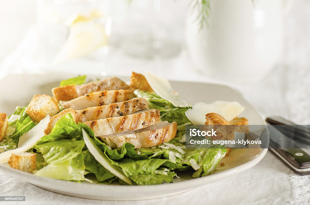 Chicken Caesar salad Chicken Caesar salad on the white plate Appetizer Stock Photo