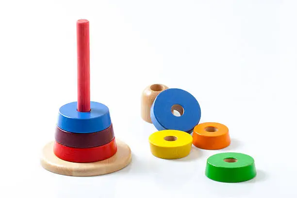 This toy is made of wooden stacking rings to be put on top of each other, forming a pyramid.