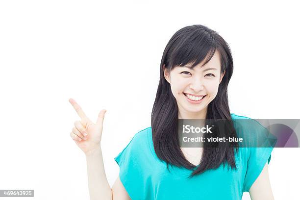 Young Smiling Woman Pointing To The Left Stock Photo - Download Image Now - 20-29 Years, Above, Adult