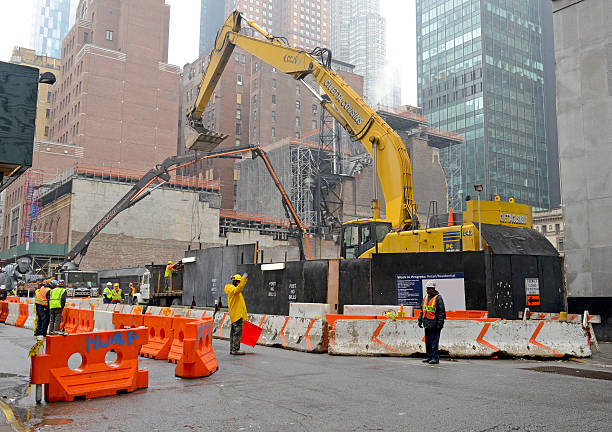 New York, USA,  April 10th, 2015: Construction workers and their equipment with “work-in-progress” building project illustrate the active commercial real estate activity in Manhattan.