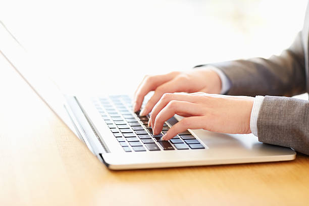 istock Cropped image of businesswoman's hands using laptop 469645394