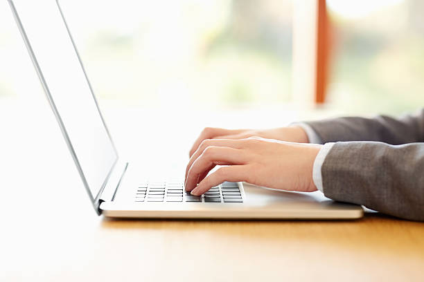 istock Businesswoman's hands typing on laptop 469645404