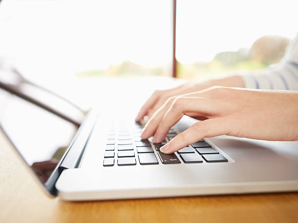 istock Cropped image of hands using laptop in bright home 469645422