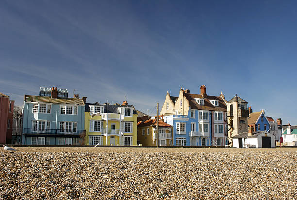 Following winter maintenance, the freshly painted houses on Aldeburgh seafront, Suffolk, England, look attractive and colourful under spring skies on this bright March day.