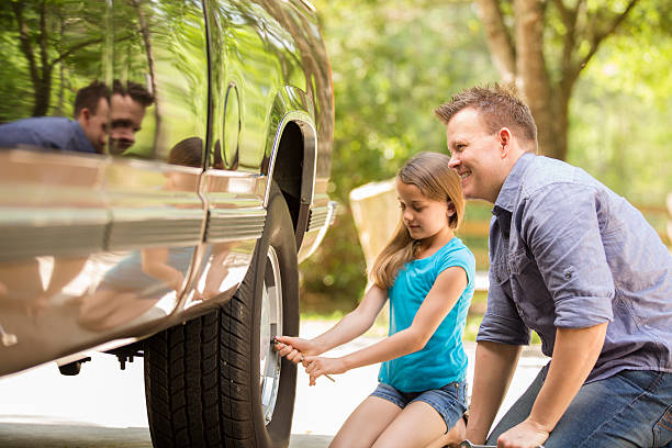 istock Daughter learning from father. Dad, child with tools, repairing vehicle. 469646112
