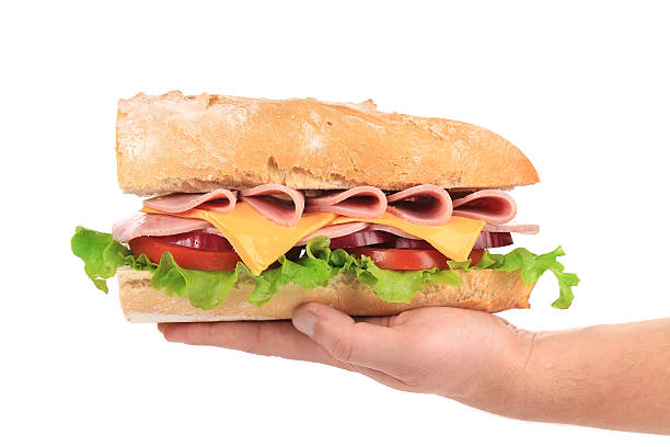 istock sandwich from freshly cut baguette on the hand 469647731