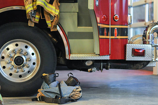 istock Fire fighter bunker turnout gear ready for action by truck 469648771