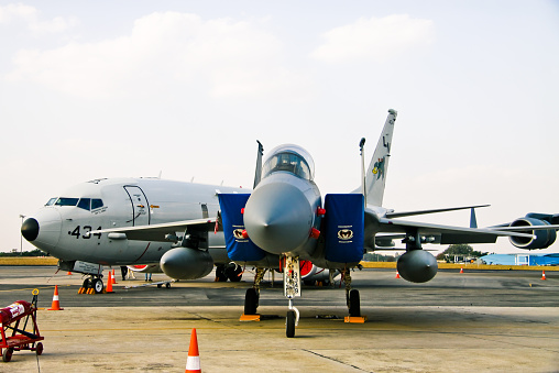 Bangalore, Karnataka, India - February 20, 2015: F-16C Fighting Falcons on static display in Aero India 2015 and Boeing P-8A in background. The tenth edition of Aero India was held from 18th to 22nd February 2015. The main attraction of this year was the Make in India campaign by Prime Minister Narendra Modi. A total of 72 aircraft were part of the air show. The main attraction of the event was the fly past and demonstration by HAL Tejas, HAL Light Combat Helicopter, Sarang display team and air display teams from Sweden, UK, Czech Republic and Open sky jump by US Special forces. A total of 11 foreign military aircraft on display, out of which a majority of them from the United states including two F-15C Eagles, two F-16C Fighting Falcons, one Boeing KC-135 tanker, one C-17 Globemaster III and a P-8A Poseidon maritime surveillance aircraft.