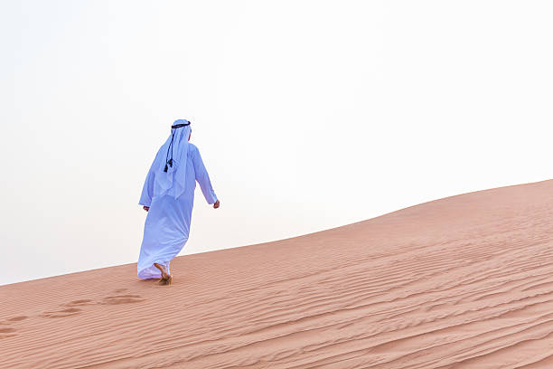 istock An Arab walking in the desert towards horizon 469649362