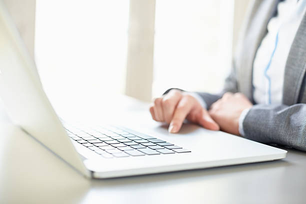 istock Cropped image of businesswoman using laptop computer at table 469649544