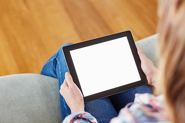 istock High angle view of woman holding digital tablet on sofa 469649552