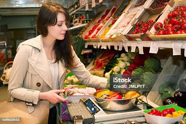 Young Woman Who Weighs Vegetables That It Is Buying Stock Photo - Download Image Now