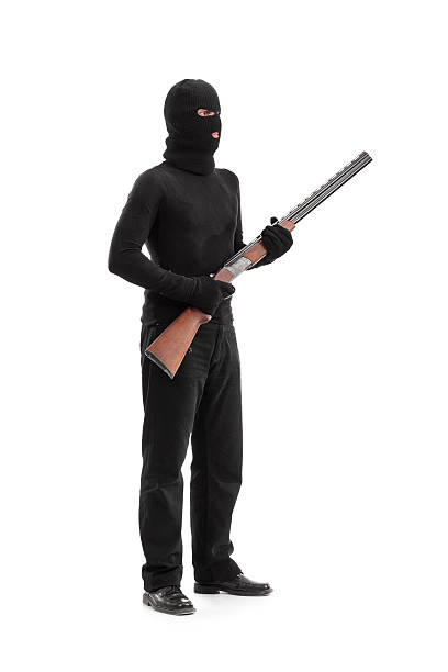 istock Dangerous criminal holding a shotgun rifle 469652130