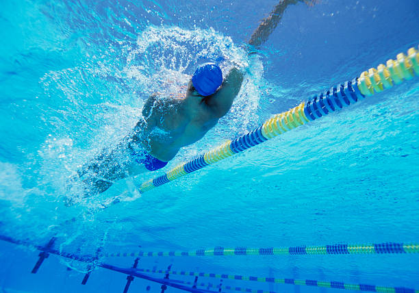 istock Young professional male athlete doing backstroke in swimming pool 469652281