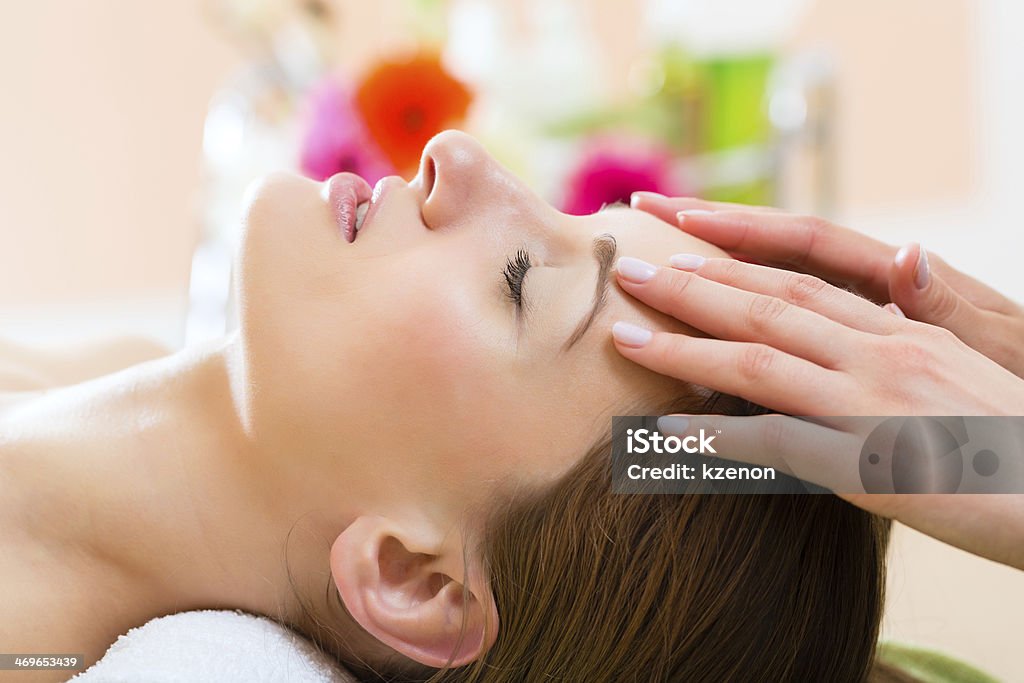 Wellness spa with woman getting head massage Wellness - woman receiving head or face massage in spa Head Massage Stock Photo