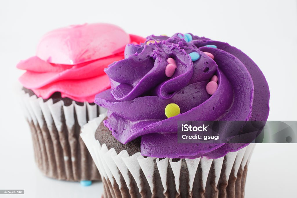 Purple and pink food Pair of chocolate cupcakes with purple and pink frosting 2015 Stock Photo
